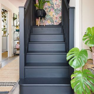 Hallway with black painted staircase