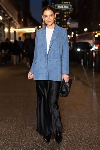 Katie Holmes wearing a blazer and satin handkerchief skirt at NYFW