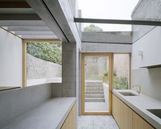 In the kitchen looking out towards the rear garden at Islington House by McLaren Excell