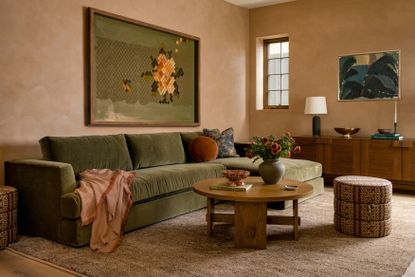 Living area with green sofa and peach walls