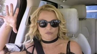 Britney Spears in sunglasses riding along in Carpool Karaoke with James Corden.