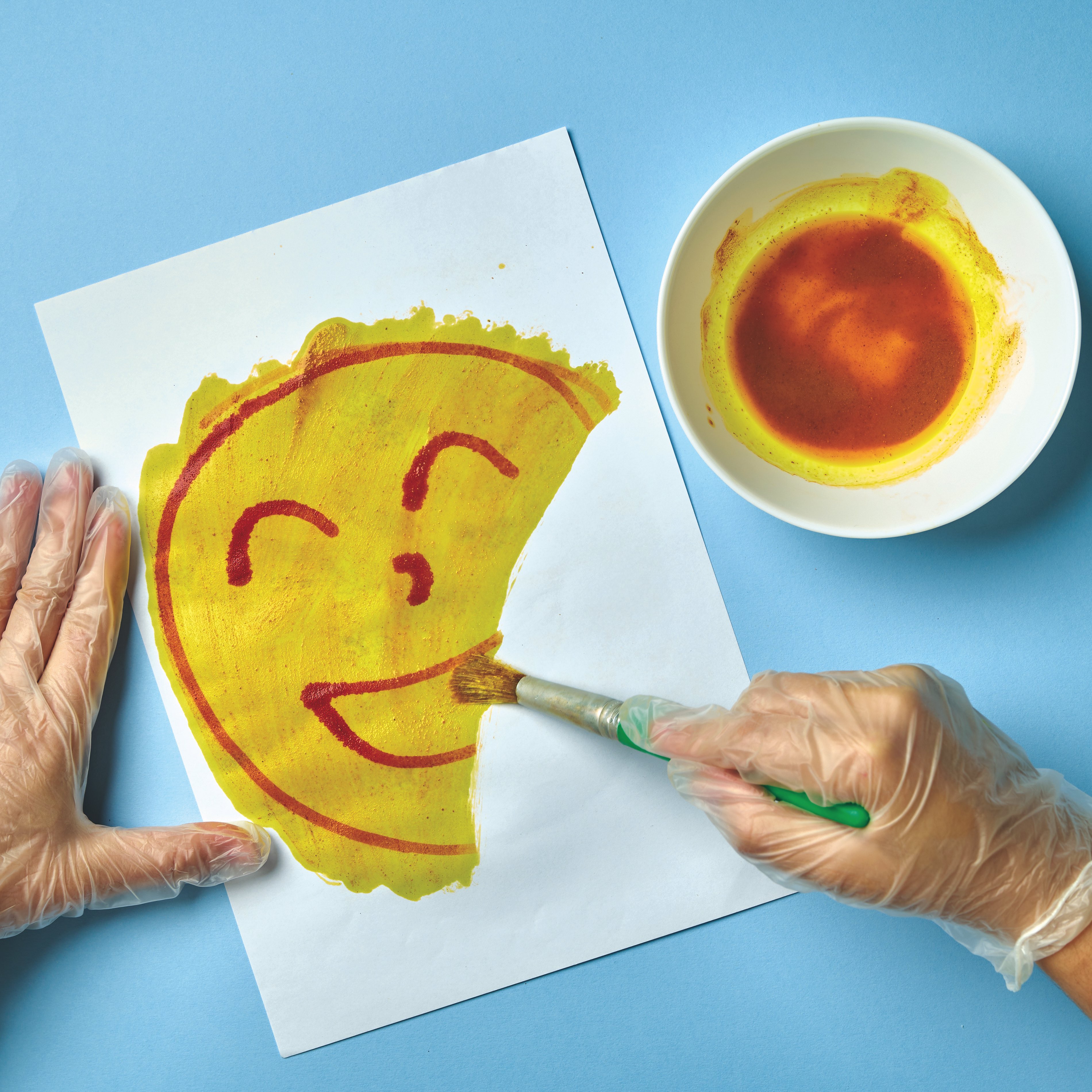 Invisible ink smiley face revealed with turmeric paste