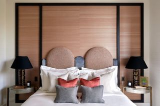 Two round cushiony orange headboards, separated with smaller rounded grey dividers