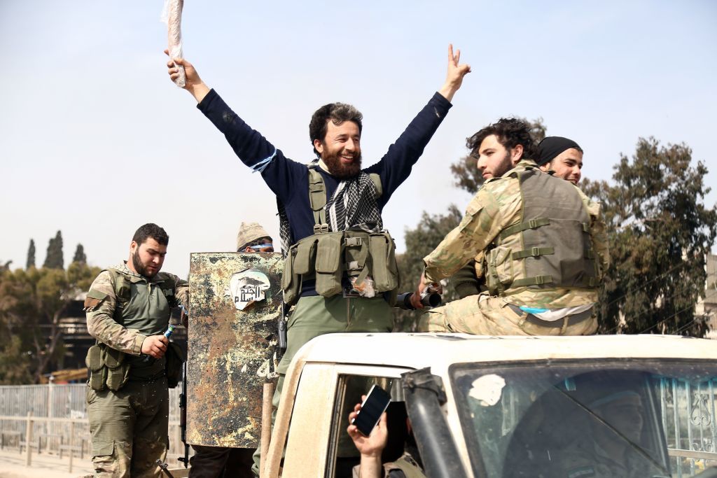 Turkish-backed Syrian rebels gather in the city of Afrin in northern Syria on March 18, 2018.