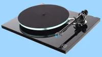 A photo of the Rega Planar 3/Elys 2, our choice of the best record players, on a blue background