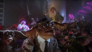 The Brain Gremlin leading a sing along in a grey suit in Gremlins 2: The New Batch.