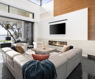 modern living room with fireplace mounted into wall and stone slab