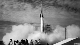 a black and white photo of a rocket launch