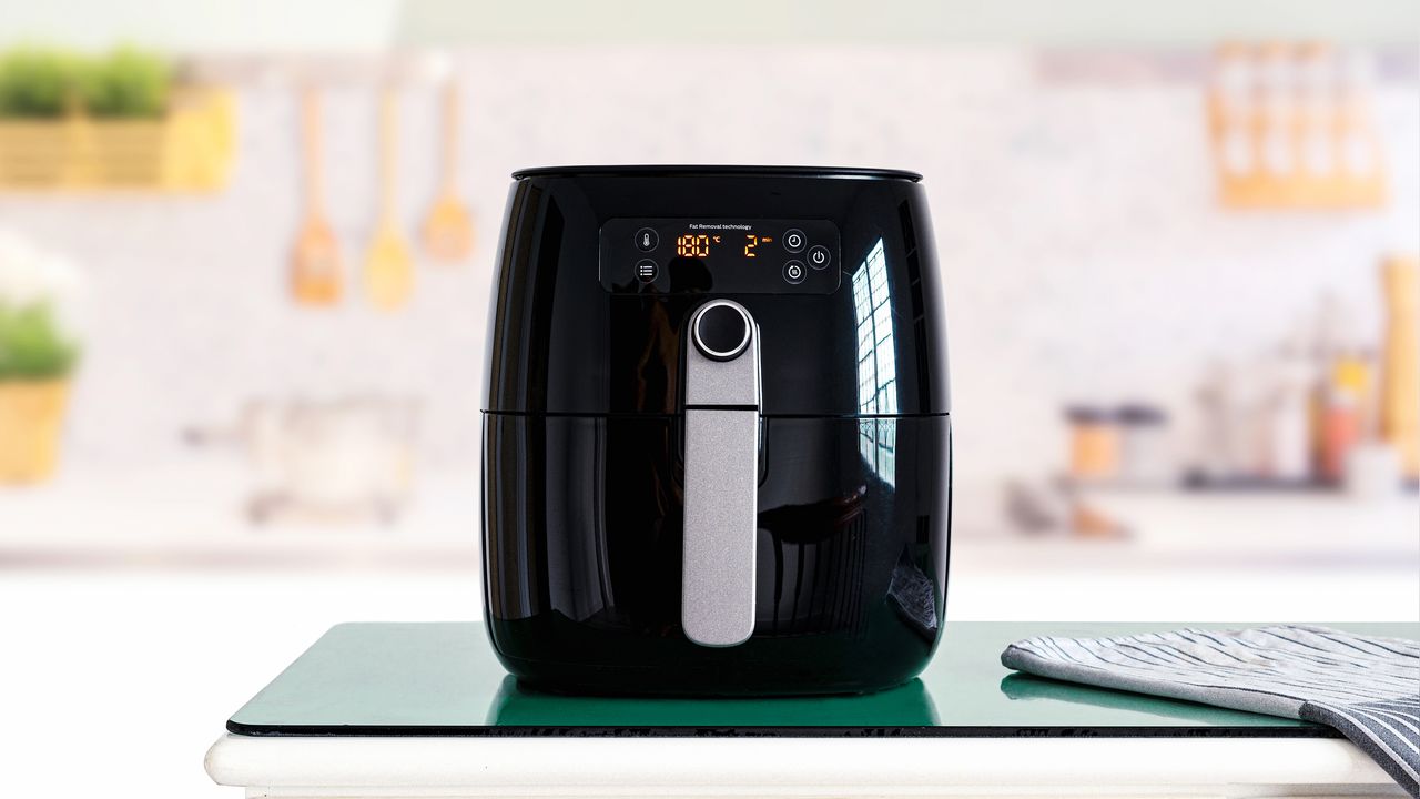 Air fryer machine cooking potato fried in kitchen