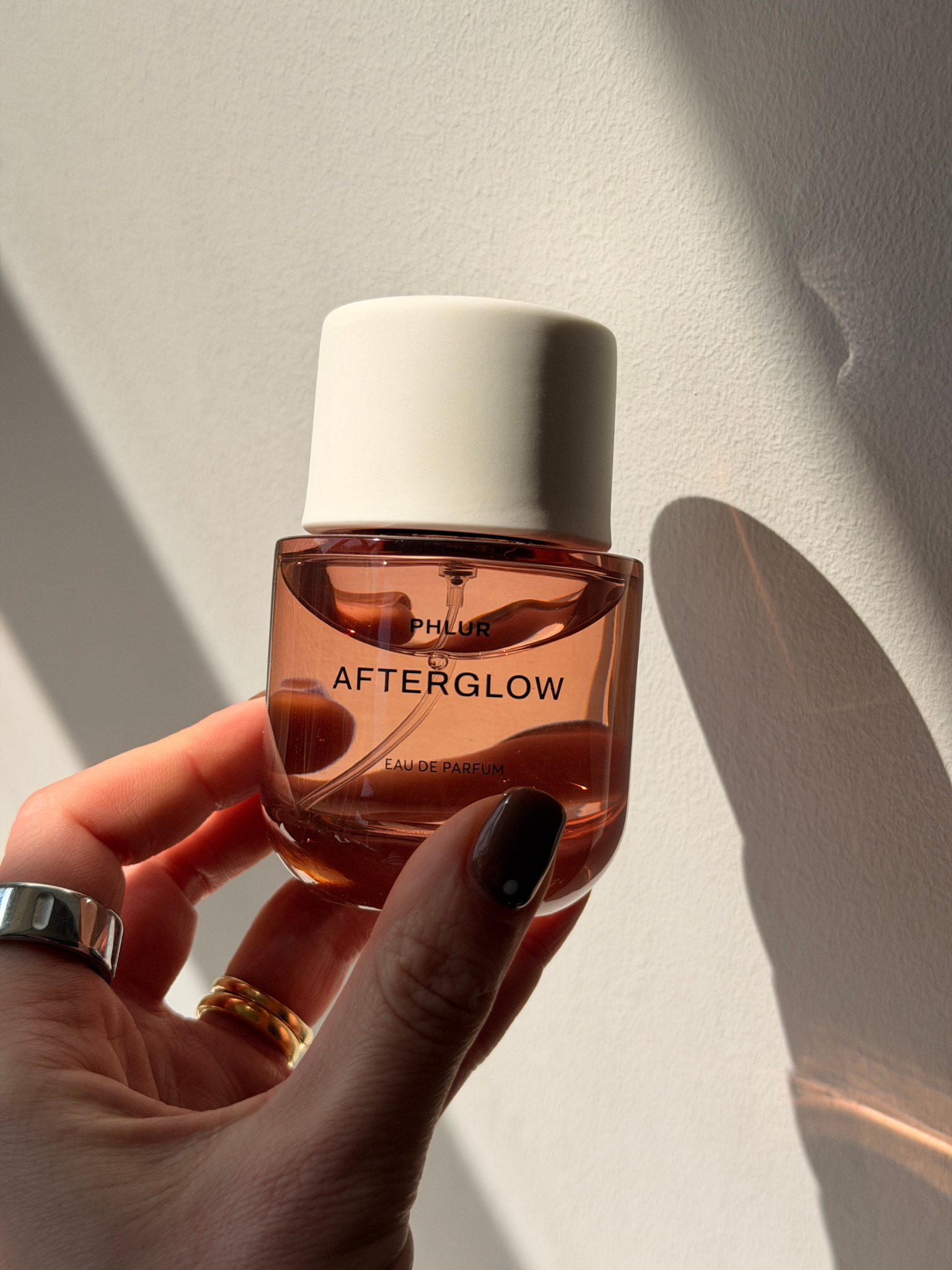 Beauty contributor Grace Day holding the Phlur Afterglow perfume