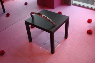 A black square table with a tortoiseshell arch on top.