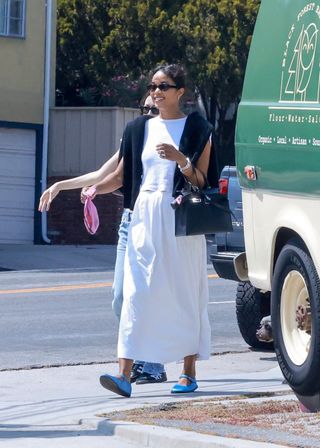 Laura Harrier wears a white maxi skirt with satin Mary Jane flats in L.A.