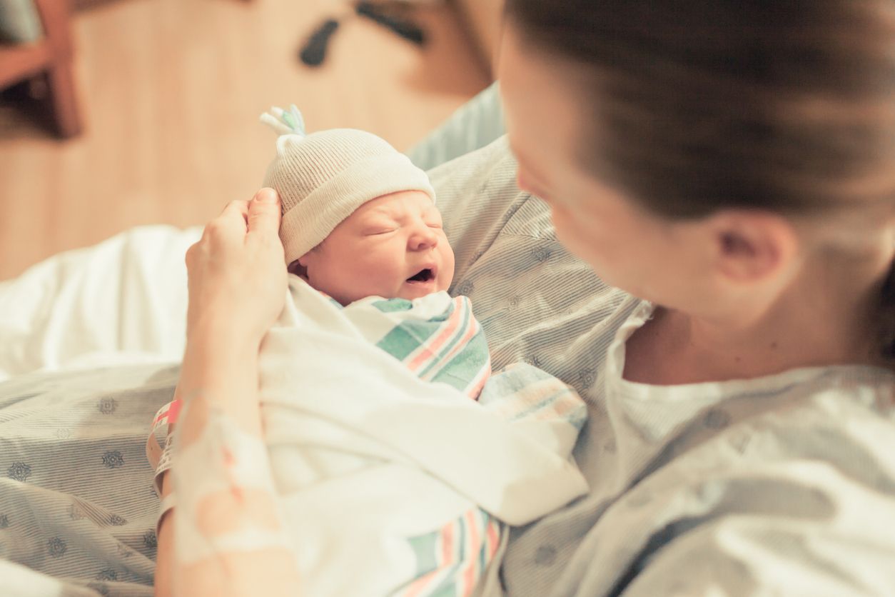 A mother holds her newborn baby.