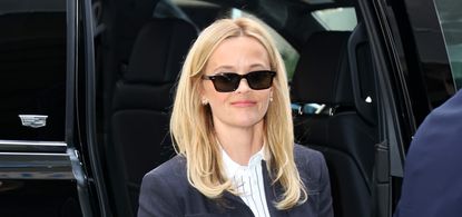 Reese Witherspoon wearing a navy blue skirt suit