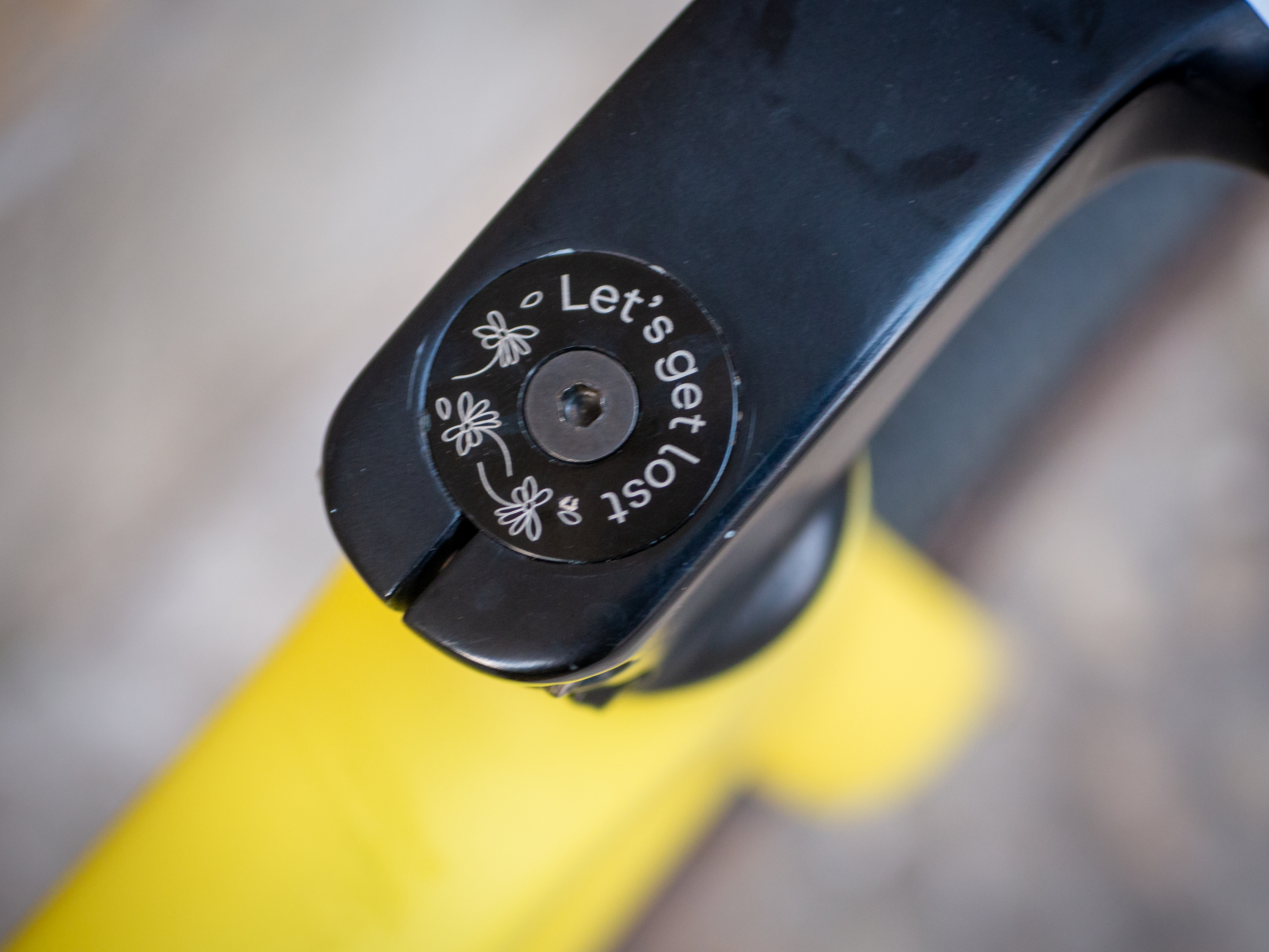 A yellow Guava Spot gravel bike leans against a wall