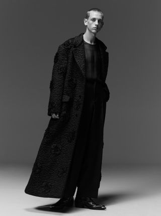 Model in black coat by Valentino A/W 2022 menswear