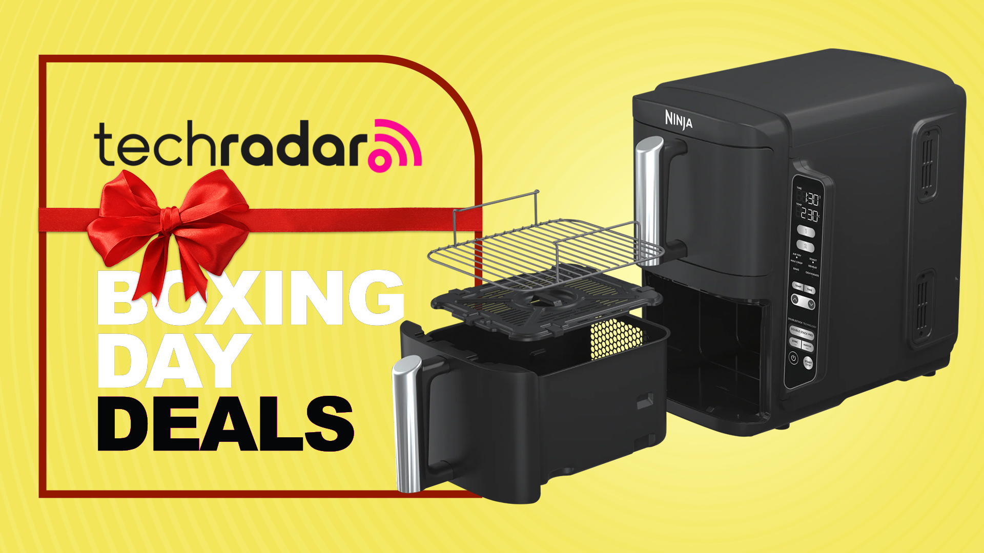 A Ninja DoubleStack XXL air fryer with lower drawer open on a yellow TechRadar Boxing Day deals background