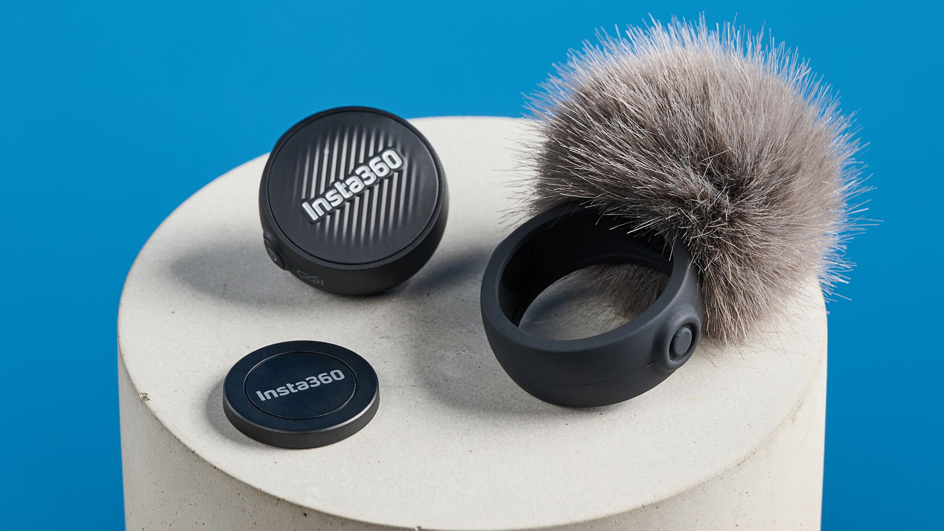 Insta360 Mic Air photographed on a blue background
