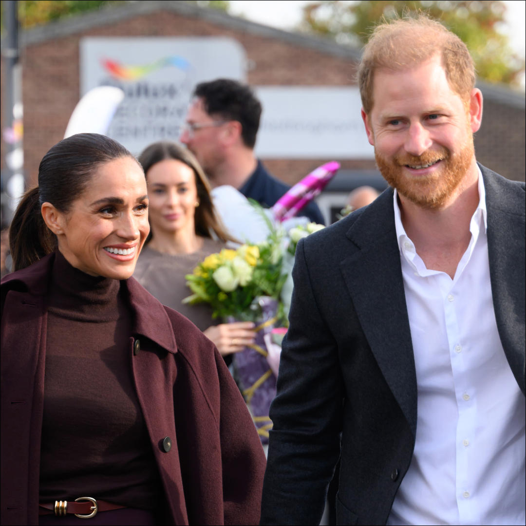 Meghan Markle wears a burgundy coat with a matching polo neck and has scraped back hair, while husband Prince Harry has red hair and wears a suit