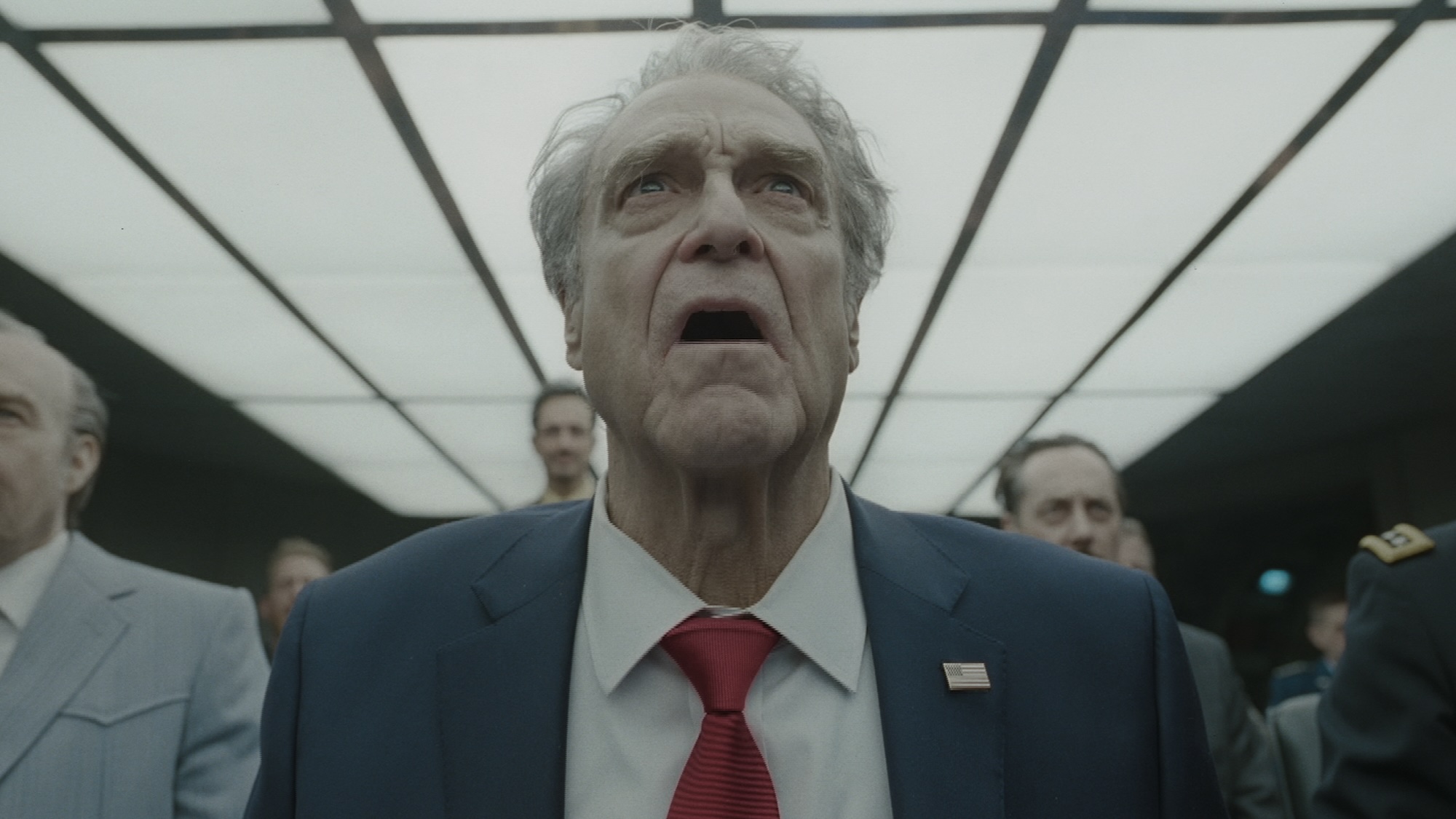 John Goodman staring upward in Digger