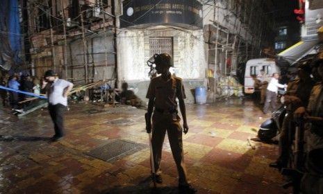 A policeman stands guard at the site of an explosion in the Zaveri Bazaar in Mumbai: Some believe the attacks that killed at least 17 people Wednesday may be the result of homegrown terrorist