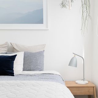 Minimal bedroom with nightstand and lamp