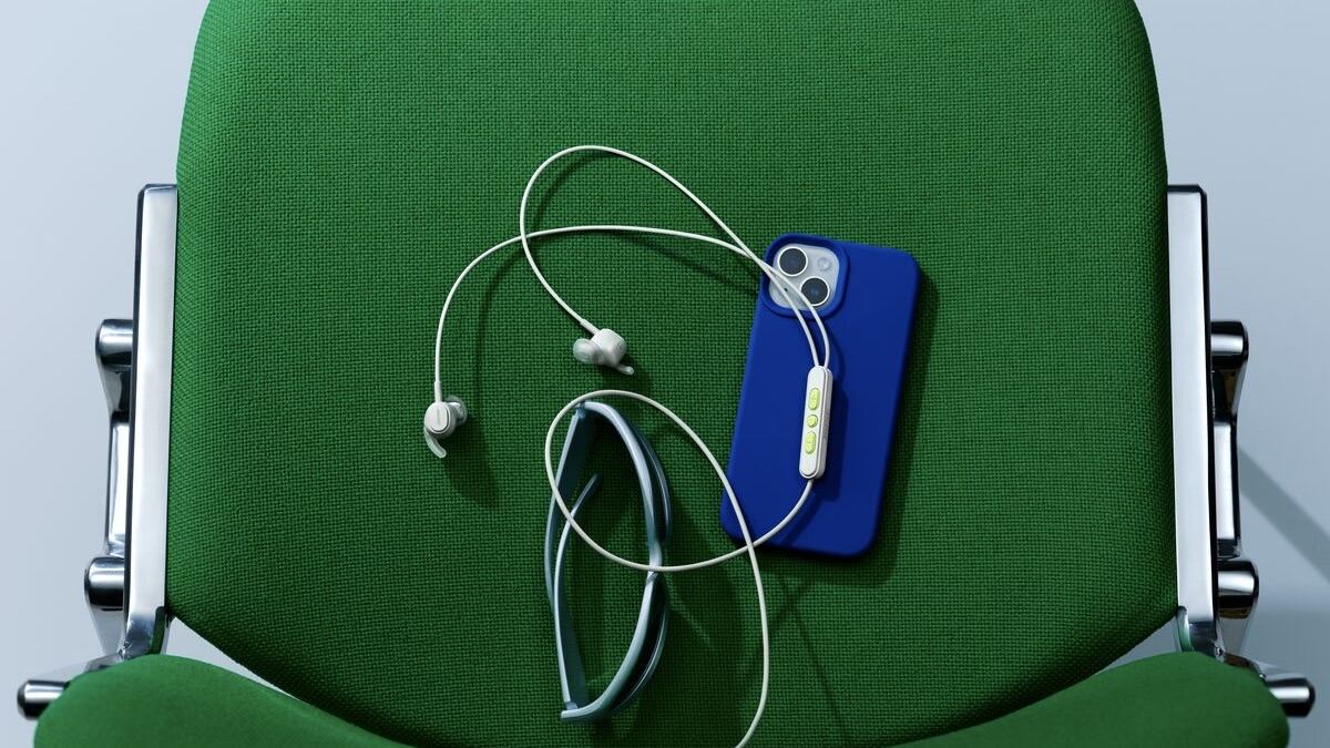 Bose Noise Cancelling Wired Earbuds on green chair with blue phone