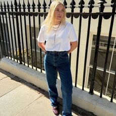 Florrie wearing white tee and jeans