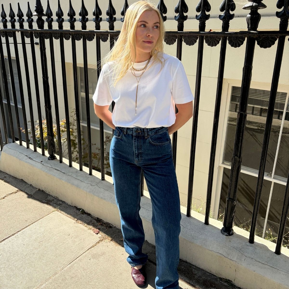 Florrie wearing white tee and jeans