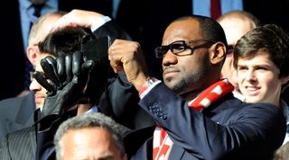 Basketball player Lebron James takes a photo during the Premier League match between Liverpool and Manchester United on 15 October, 2022 at Anfield in Liverpool, United Kingdom.