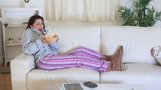 Woman watching scary movie at home