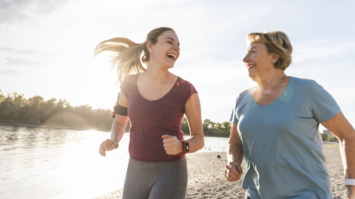 Two women run on the beach