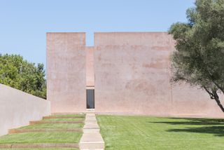 Exterior view of pink Mallorca house designed by John Pawson