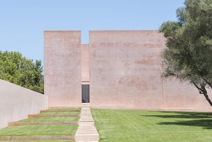 exterior of pink majorcan house designed by john pawson 