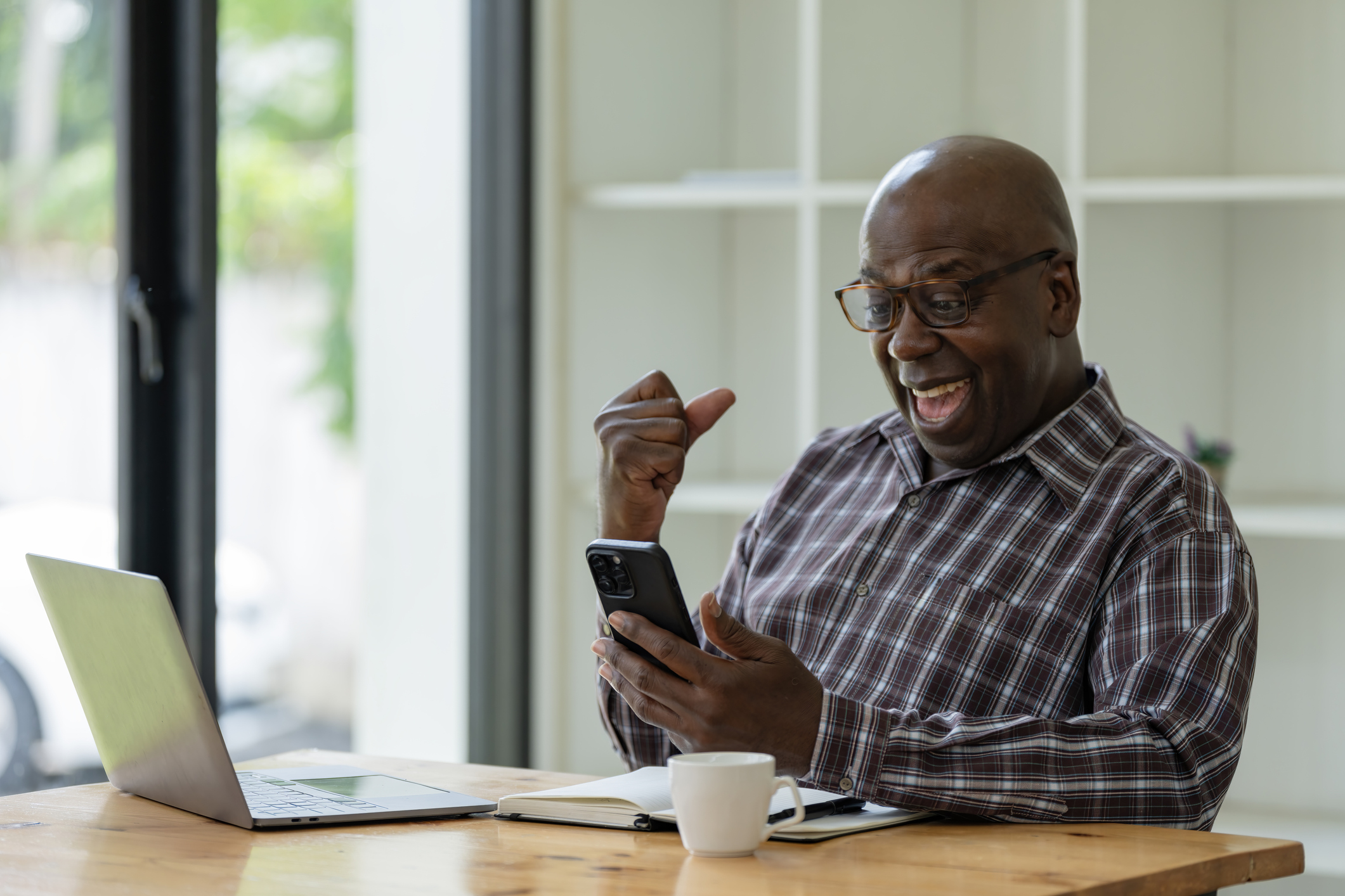 A happy dude excited by something he read on his phone
