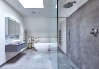 grey and white bathroom with shower, vanity unit, large basin, concrete style floor and walls tiles