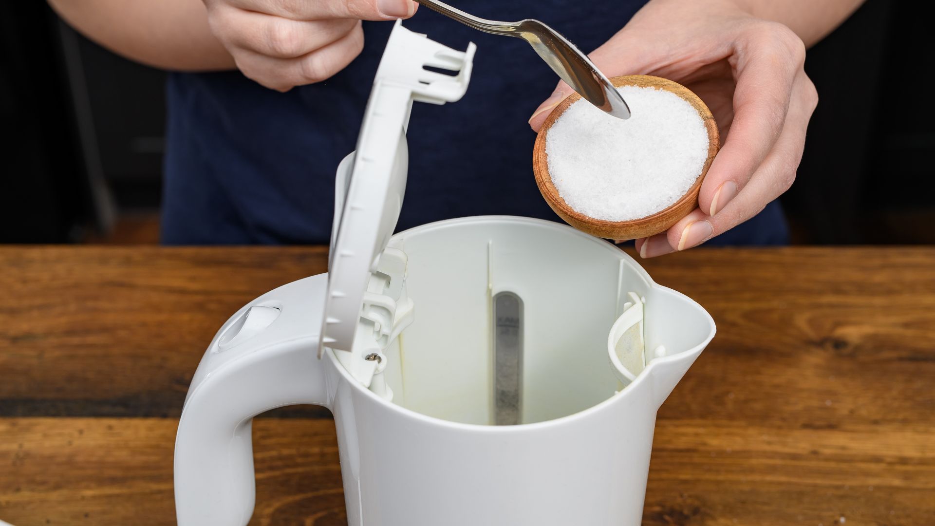person putting citric acid in kettle