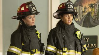 Maya and Andy side by side in their firefighter gear in Station 19 season 6