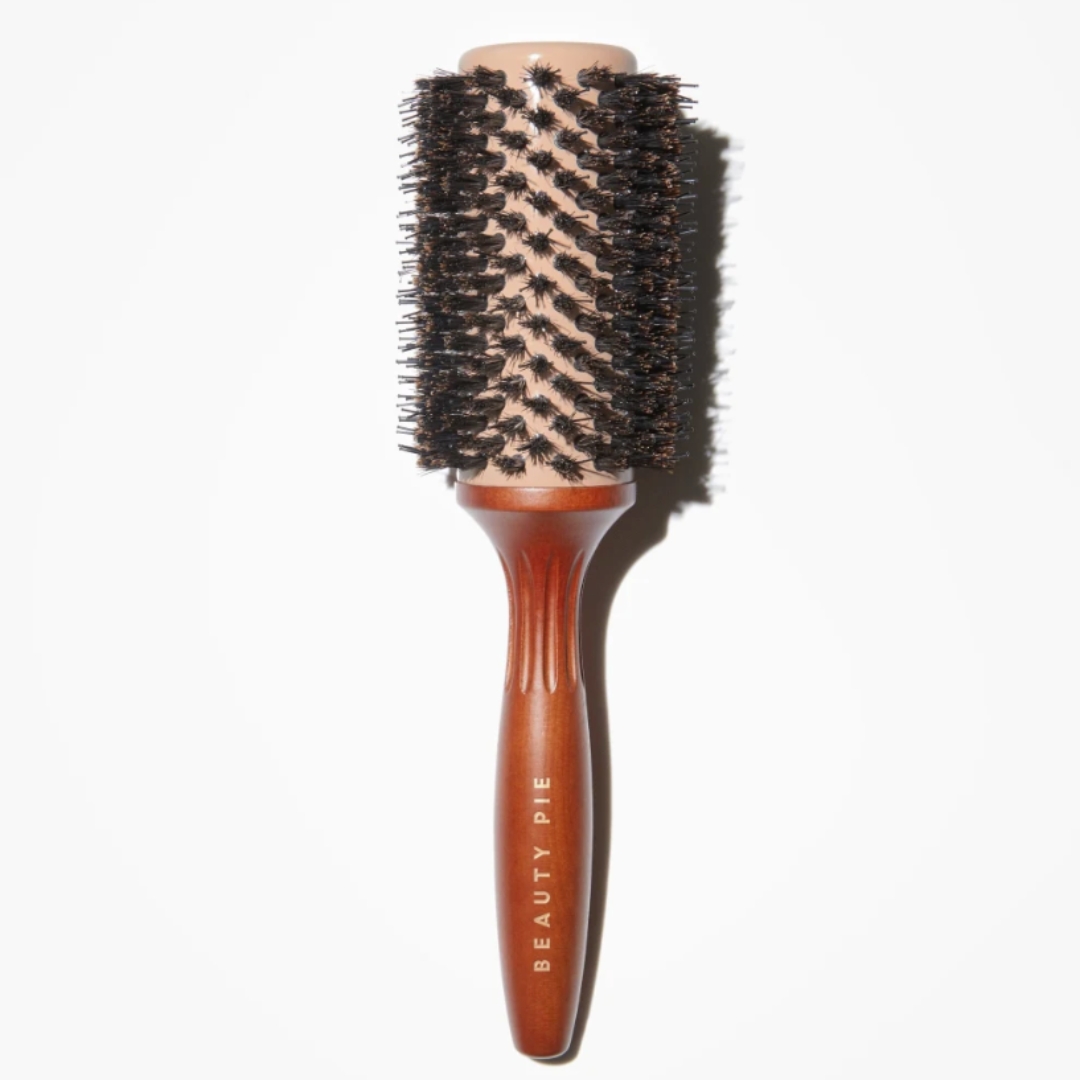 A product shot of the Beauty Pie Super Healthy Hair Pro-Dry Barrel Brush (43mm), on a grey headline