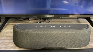 Soundbar in front of TV screen