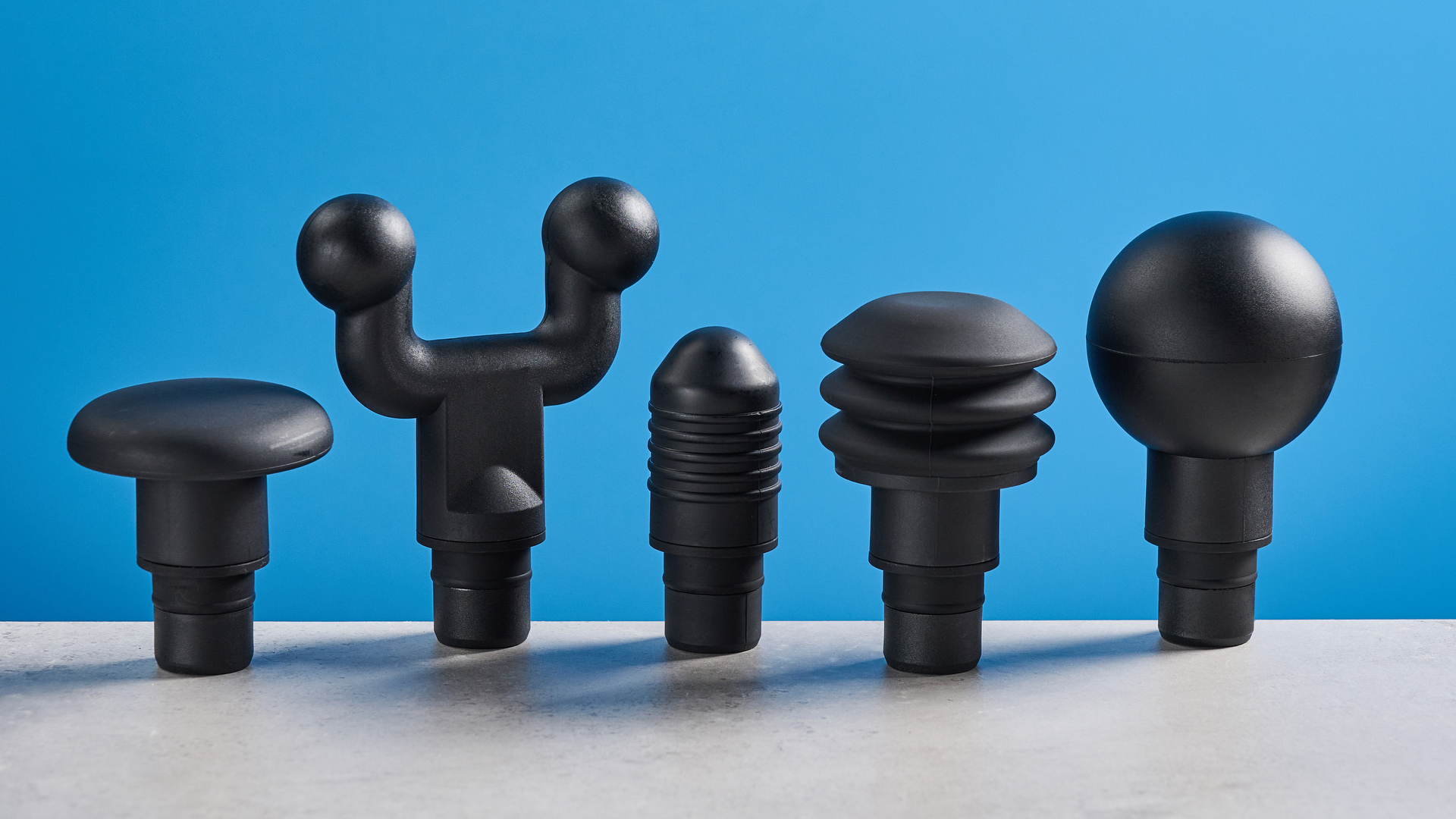 the hyperice hypervolt 2 pro massage gun with a long ergonomic handle and interchangeable massage head attachments