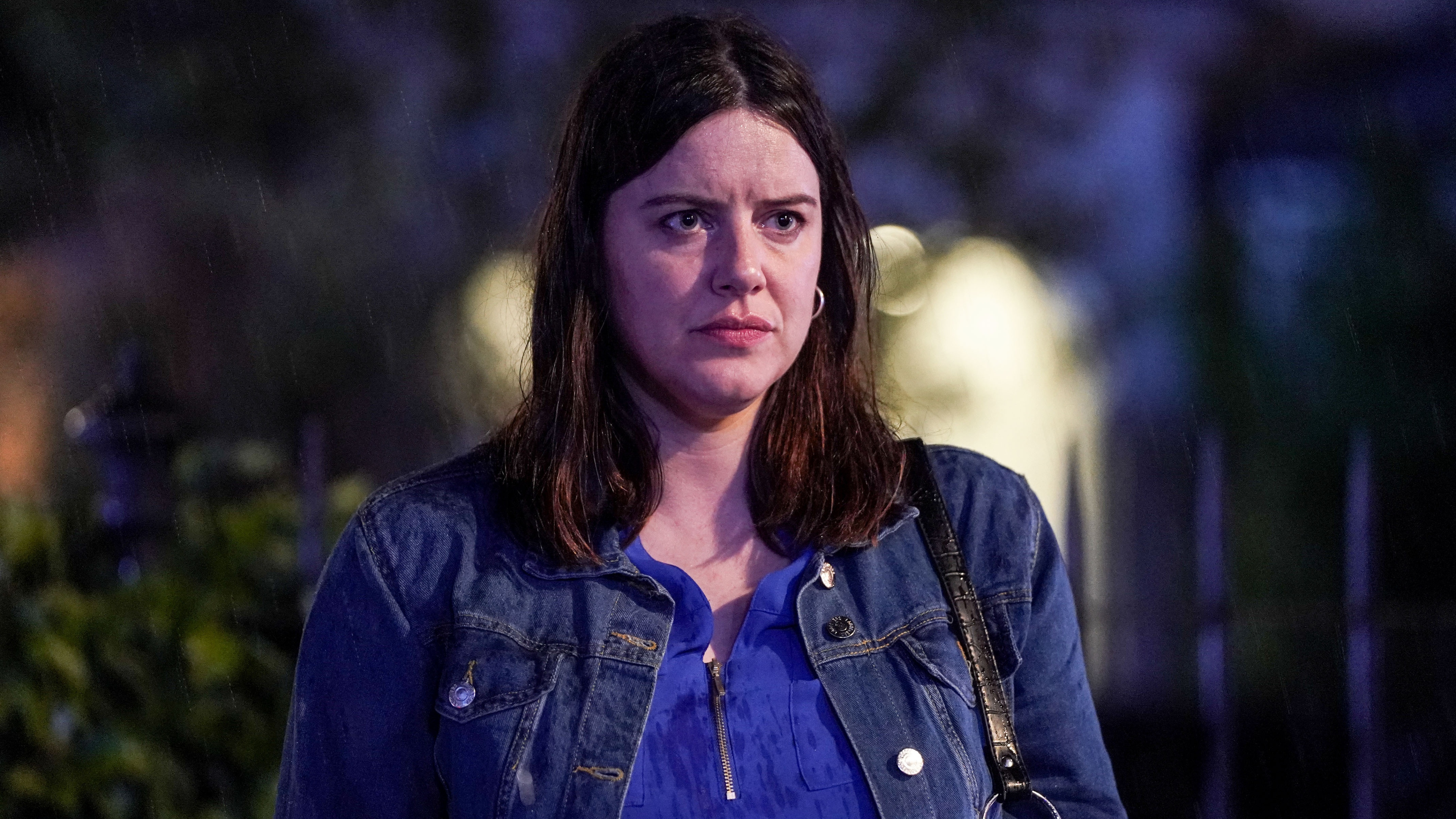 Zoe looking scared as she looks at Kat, who is off camera, while standing in Albert Square at night