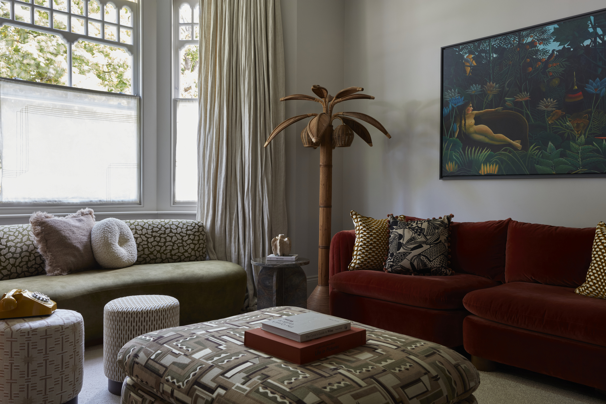 Run For The Hills designed living room with two low back sofas and a pouffe in the centre