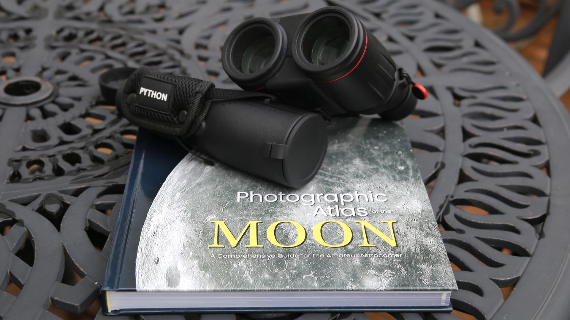 Binoculars and monocular on a book about the Moon.