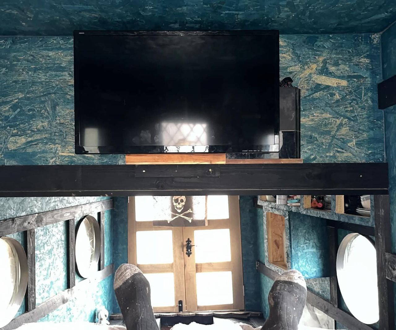 A TV on a wall in a boat house