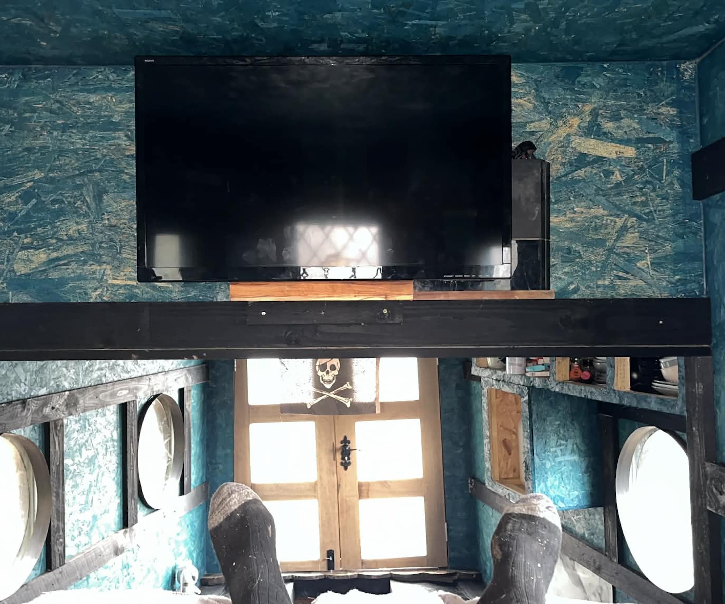 A TV on a wall in a boat house