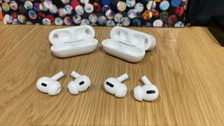 AirPods Pro and AirPods Pro 2 with their charging cases on a table