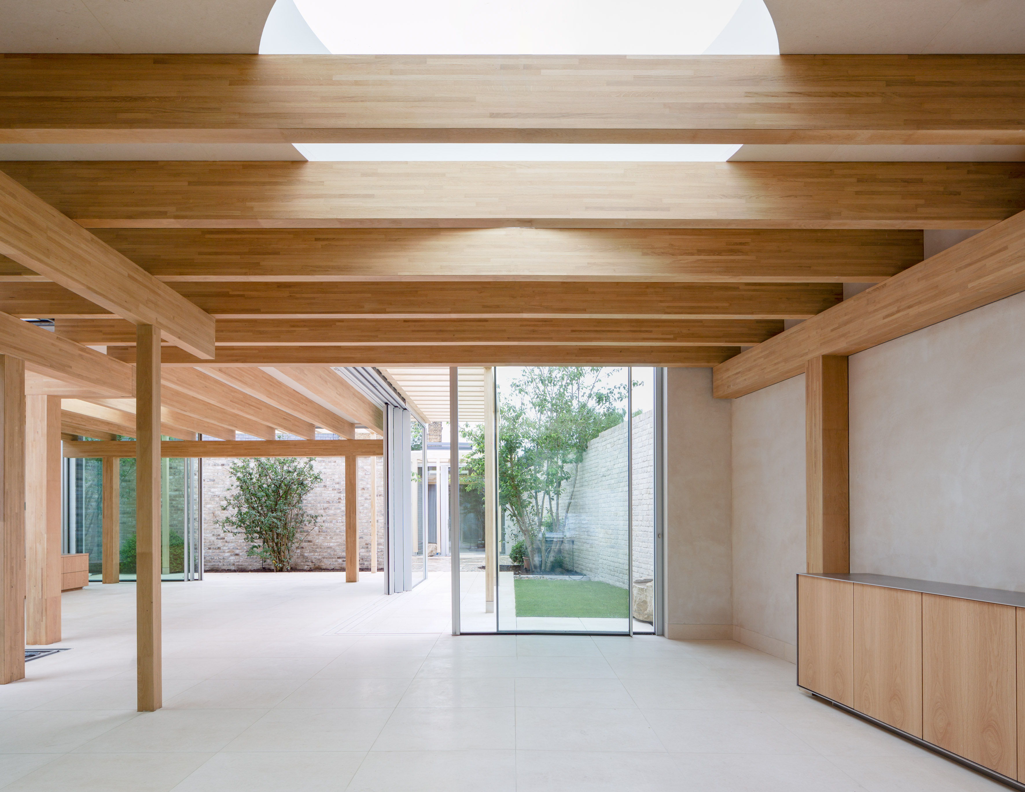 A spacious domestic house interior with wooden beams