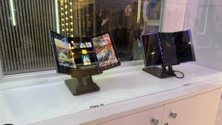 The Samsung tri-fold Flex G and Flex S concept smartphones behind a glass display at MWC 2025.