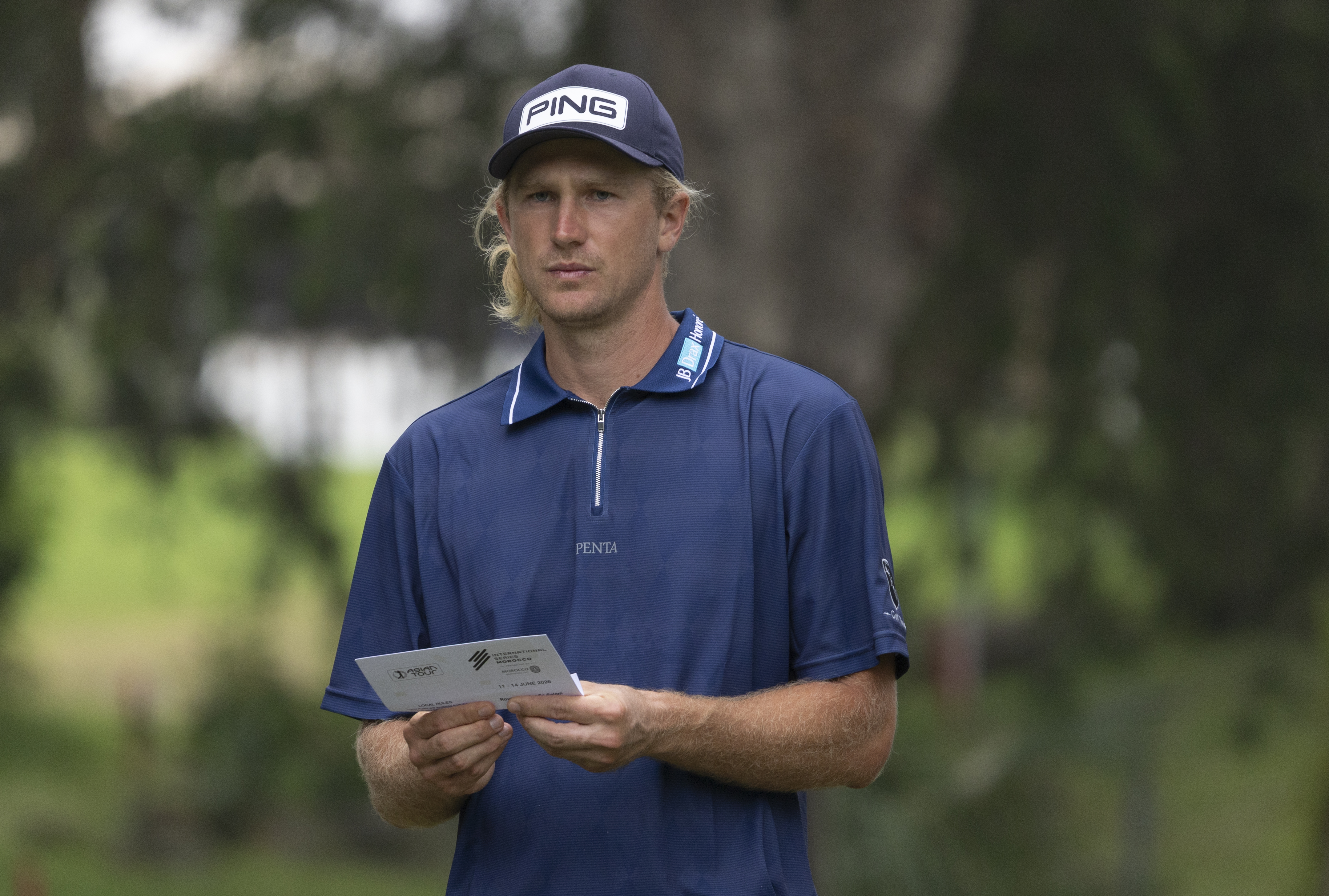 Travis Smyth checks the card
